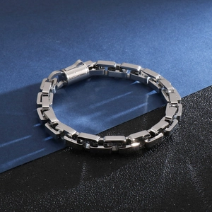 Close-up of polished silver square link chain bracelet with secure press clasp mechanism