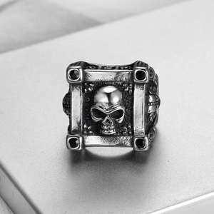Detailed view of punk skull ring with four black cubic zirconia stones in retro silver