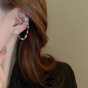 Macro shot of silver star fringe tassel ear cuff with sparkling zircon stone details