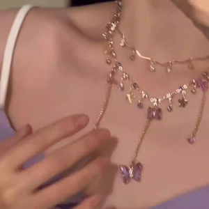 Double layered purple butterfly pendant necklace with crystal beads on model