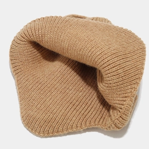 Detail of caramel ribbed knit beanie showing thick texture and warm interior lining