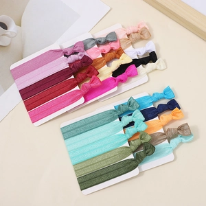 Detail shot of colorful knotted elastic fabric hair ties on white display cards
