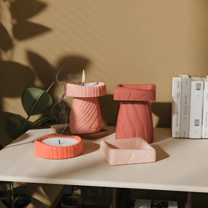 Detail of pink and coral gradient candle holders with elegant organic wave textures