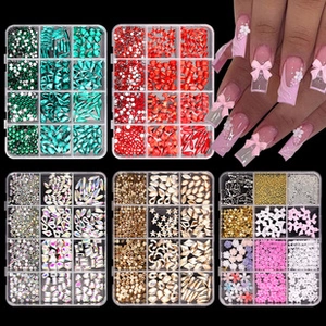 Detailed view of 5 boxes of colorful nail glitter sequins and charms for professional nail art
