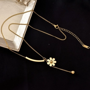 Elegant gold stainless steel necklace with hex petal flower pendant and hanging gold bead