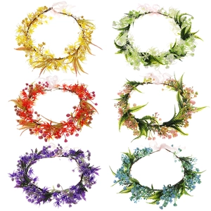Assorted artificial floral wreaths with vibrant berries and green leaves on white background