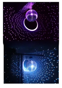 Close-up of sparkling silver disco ball showing colorful light reflections and mirror tiles