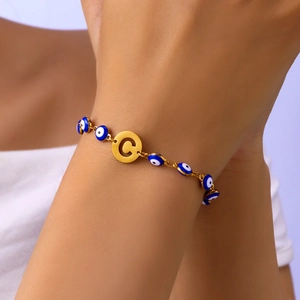 Detailed close-up of Evil Eye beaded bracelet with personalized gold letter C pendant