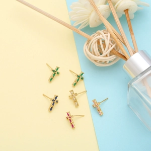 Detail of cross stud earrings with colorful cubic zirconia in gold plating and micro pave