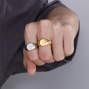 Minimalist stainless steel rings in gold and silver finish worn by a man on his fingers