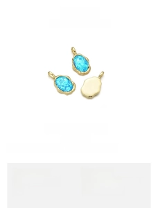 Macro view of blue opal irregular pendant charm in 18K gold plated copper