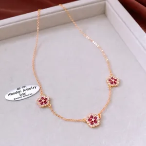 18K gold plated necklace featuring three floral pendants with red rubies and white crystals
