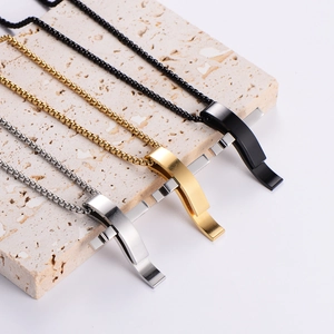 Three minimalist stainless steel cross pendant necklaces in silver, gold, and black colors
