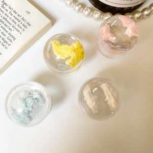 Detailed view of cloud-shaped crystal ball phone grips in pink, yellow, blue, and white colors