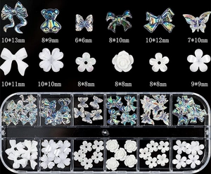 Macro view of Aurora nail art charms including 3D bears and flowers with size details