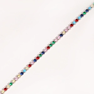 Close-up of a silver tennis bracelet featuring vibrant multi-colored claw-set zircon stones