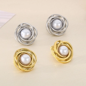 Detailed view of pearl stud earrings with twisted metal borders in gold and silver