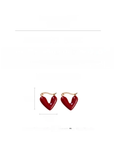 Detailed view of red enamel heart earrings with gold finish and 1.9cm dimensions