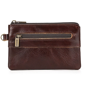 Detail of vintage dark brown crazy horse leather wallet with zippers and brass hardware