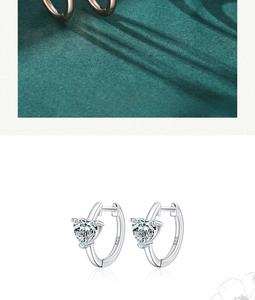 Detail shot of heart-shaped S925 sterling silver earrings with clear cubic zirconia