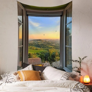 Detail of bohemian tapestry featuring an open window view of a Tuscany sunset landscape