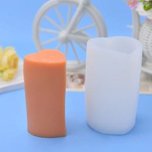 DIY heart-shaped acrylic candle mold with orange pillar candle on a bright blue background