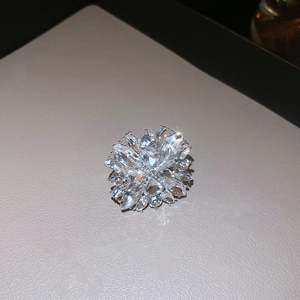 Detailed macro view of a silver floral ring featuring sparkling crystal petals and facets