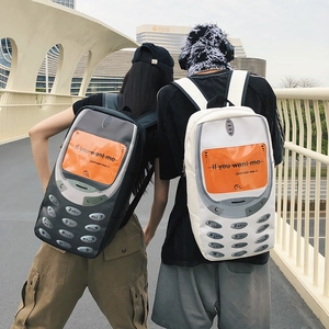 Minimalist cell phone style backpack for students in gray and white colors on a bridge