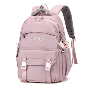 Close-up of pink nylon backpack featuring multi-pockets and a heart-shaped charm