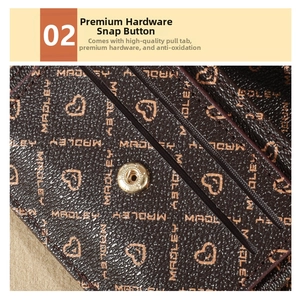 Detail of printed leather wallet with gold hardware snap button and card slot design