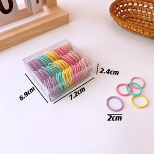 Detail view of 130 colorful mini seamless hair ties in a clear 7.2x6.9cm storage box