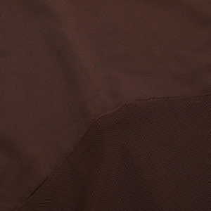 Detail of dark brown dress fabric showing mesh patchwork and fine knit texture