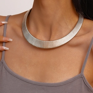 Detail of silver choker necklace featuring vertical textured patterns on a wide metal band