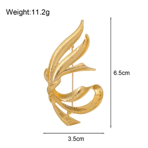 Vintage ribbon bow gold brooch with textured metal surface for suit jacket