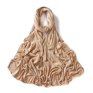 Detail of the soft modal jersey hijab in apricot beige with premium drape and texture