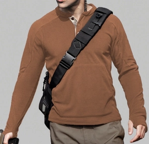 Detail of brown fleece sweatshirt fabric and tactical cross-body bag on male model