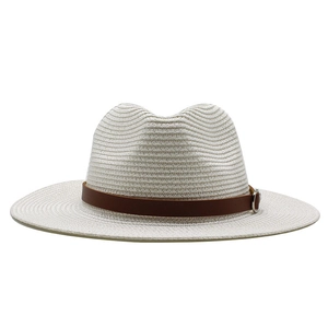 Close-up of the woven texture on a cream fedora with a brown leather decorative band