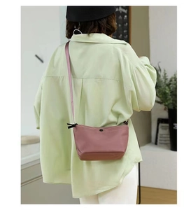 Pink dumpling-style crossbody bag shown on model back for size and daily styling
