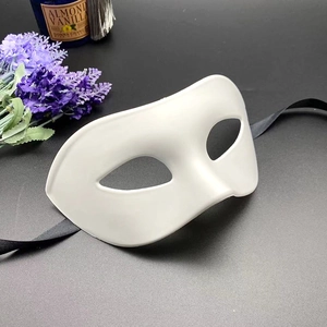 White half-face masquerade mask with black ribbons on dark background with purple flowers