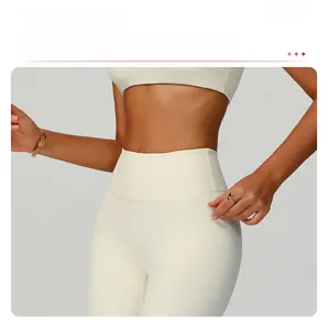 Detail of high-waist cream yoga pants showing seamless compression fabric and tummy control