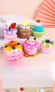 Macro detail of artificial dessert charms with cream fruit topping and love script