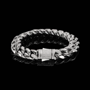 Detailed view of silver Cuban chain bracelet with crystal-encrusted spring clasp on black base