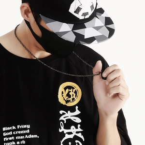 Detail of a punk style stainless steel chain necklace worn with a black graphic tee