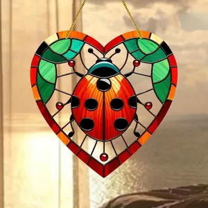 Acrylic heart suncatcher with red ladybug design and green leaves for garden decoration