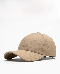 Detail view of khaki baseball cap with embroidered W monogram pattern and twill texture