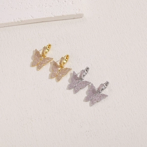 Elegant gold and silver butterfly drop earrings with sparkling pink cubic zirconia stones