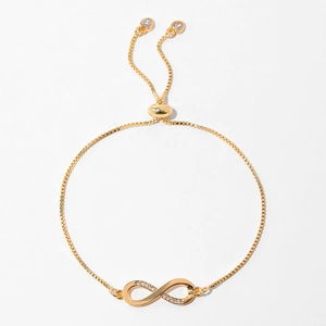 Macro view of gold infinity bracelet with zircon stones and adjustable box chain