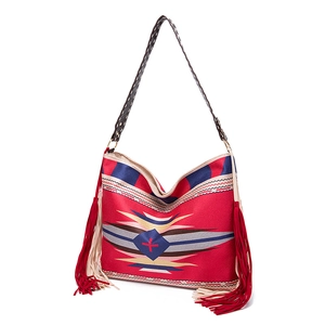 Close-up of Bohemian woven shoulder bag with colorful wave patterns and long side tassels