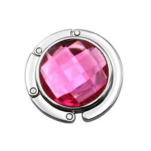 Detail of pink crystal round foldable bag hanger with shiny silver metal finish