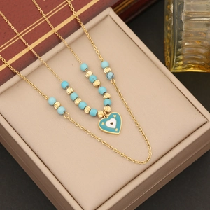 Bohemian gold layered necklace with blue heart pendant and turquoise beads in jewelry box